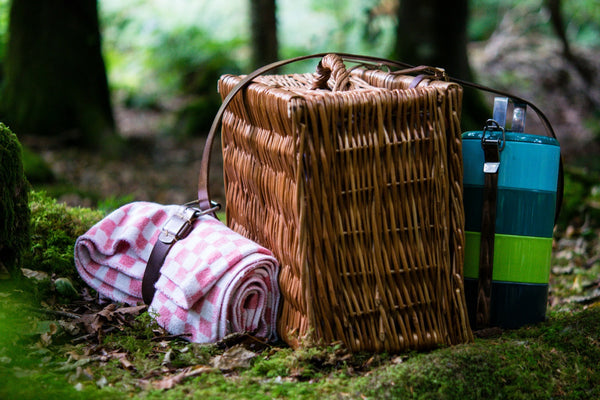 wicker picnic basket with a folded blanket