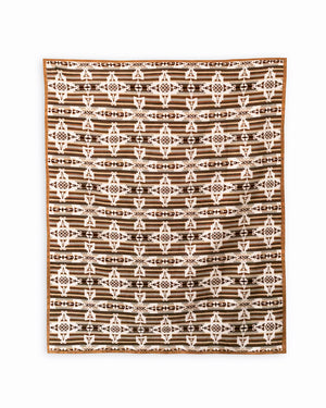 Reverse side of mother and child brown blanket. Brown and beige stripes on the background, on top are repeated geometric white mother and child symbols in a shape of a cross