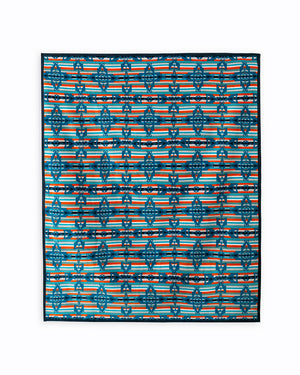 Reverse of the blanket is a stripe background made out of light blue, orange and white stripes, the crosses are in dark blue, repeated horizontally and vertically