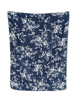 A navy blue blanket or throw with an all-over white floral and vine pattern, shown hanging flat against a plain white background.